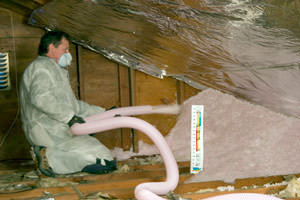 Fiberglass Insulation being used to add energy efficiency to an attic in Ocala